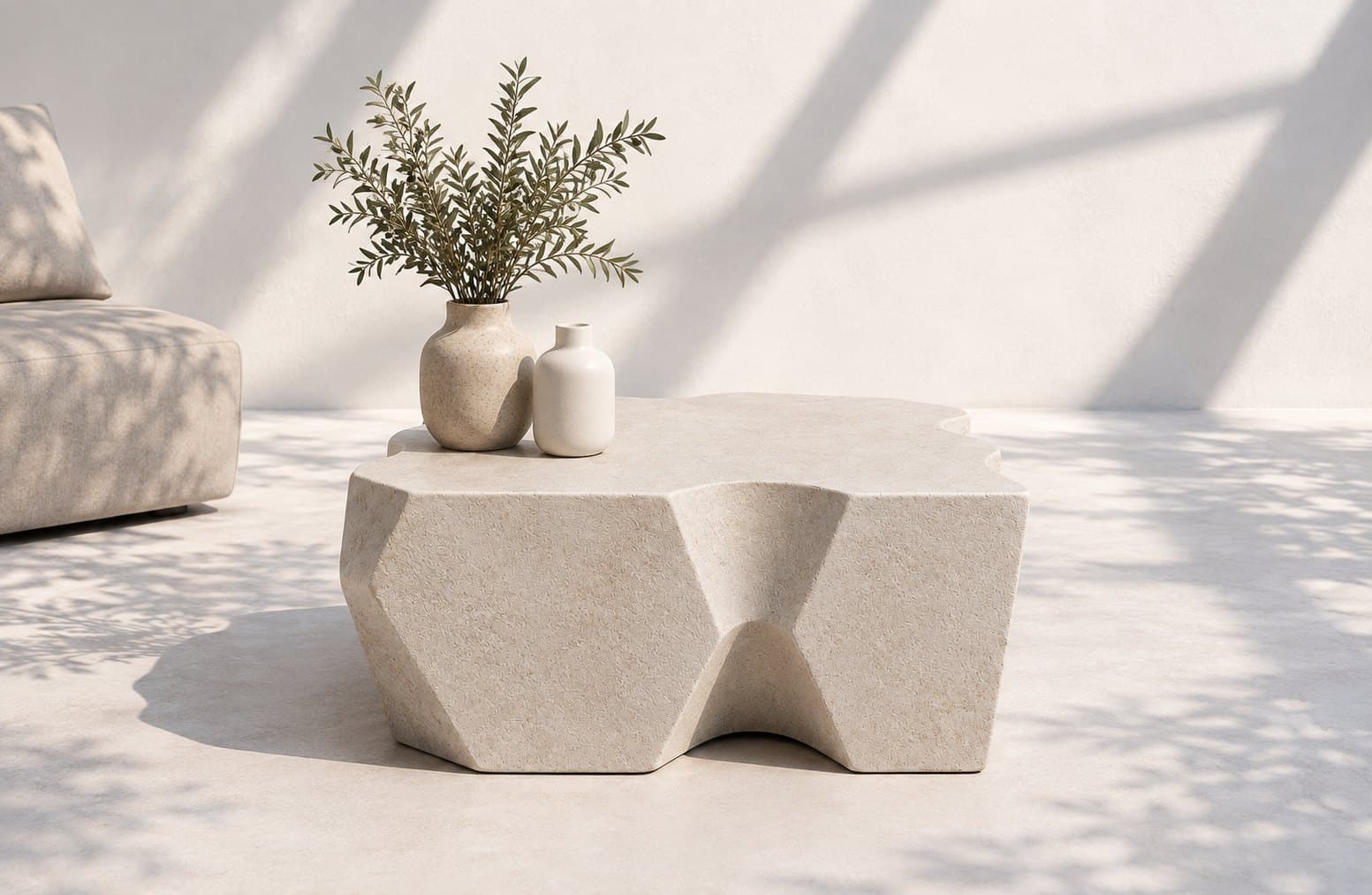 A faceted coffee table with an irregular, hand-carved presence — every angle catching the light differently.